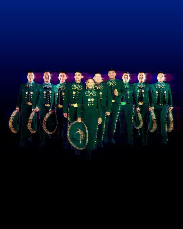 The ten members of Mariachi Herencia de Mexico standing in a line wearing their stage uniforms and holding their hats to the side